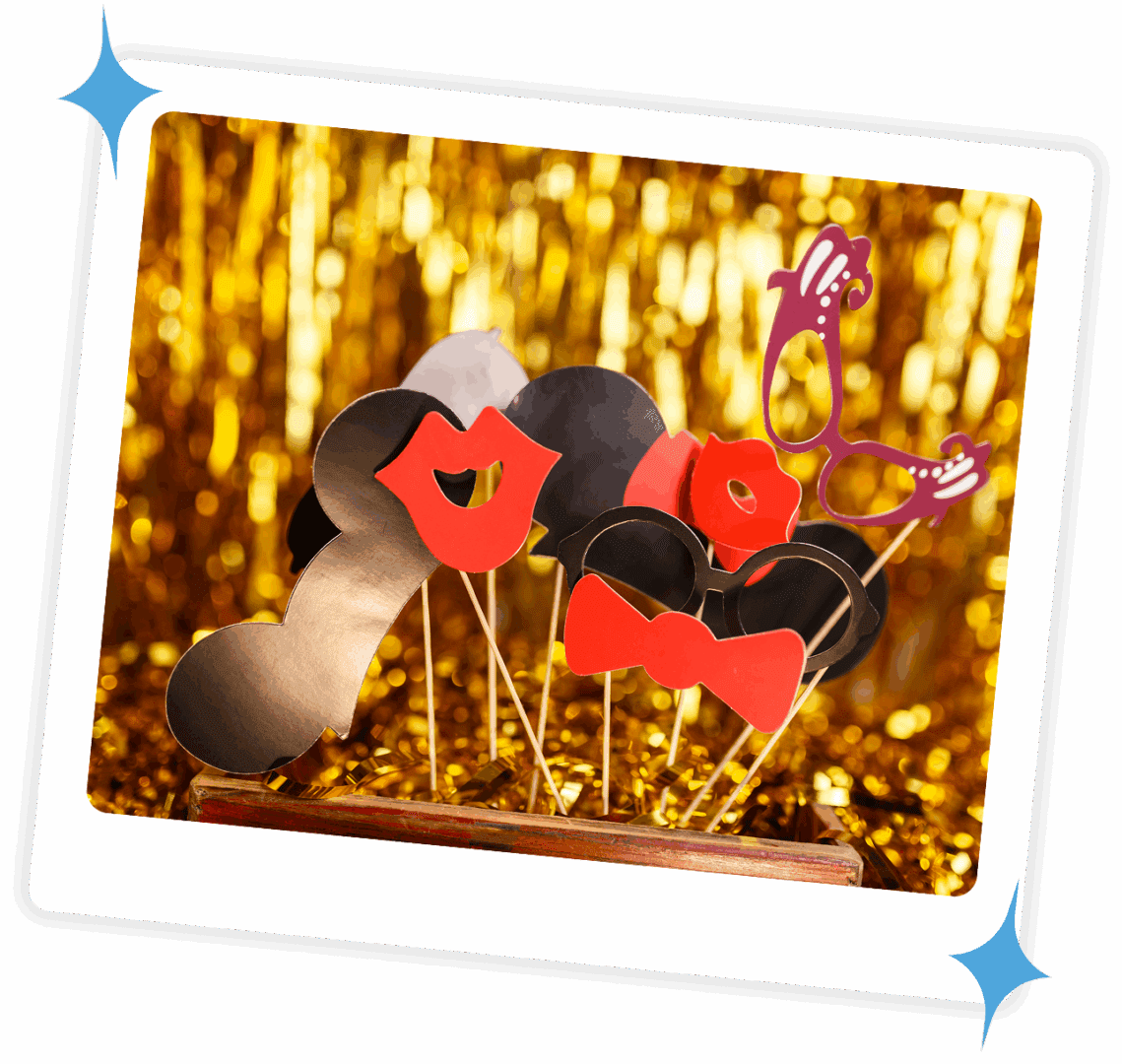 Photo booth props with lips, mustache, and glasses on sticks against a gold sequin backdrop.